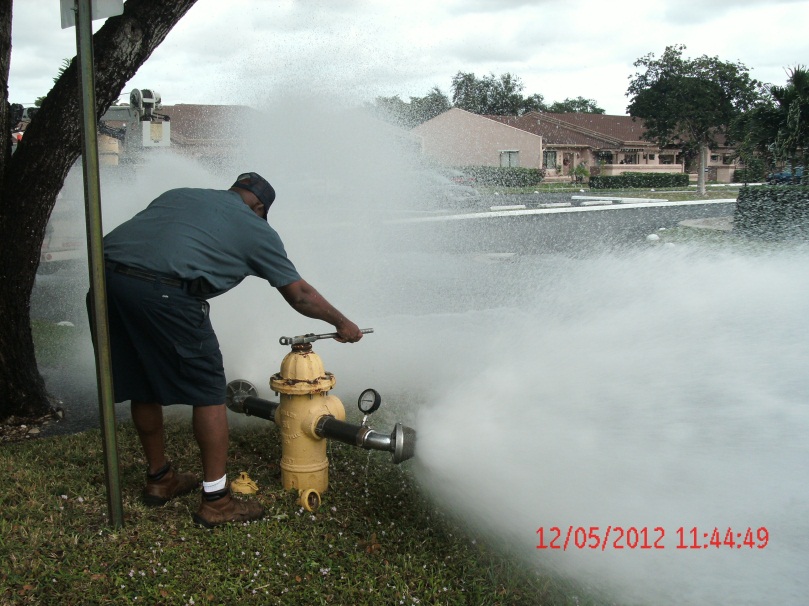 A crew member  flushes one of the City’s 3,618 fire hydrants as part of the annual maintenance program.